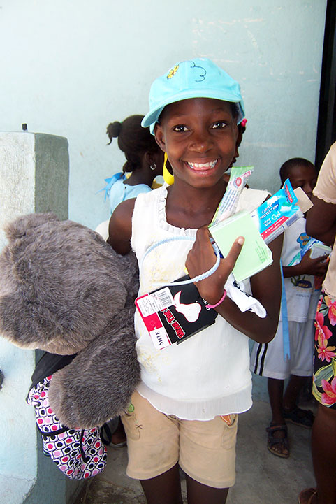 A young girl holding a teddy bear.