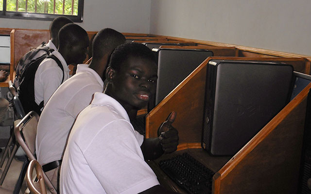 A group of people sitting in front of computers.