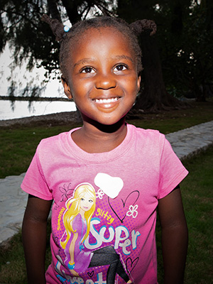 A girl wearing a Chrisnara Auguste t-shirt.