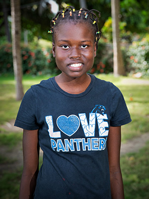 A young girl wearing Starchise Jean t - shirt.