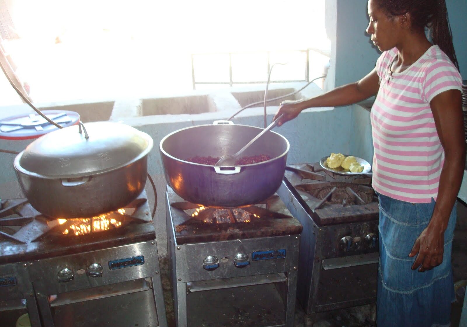 A woman preparing food in a kitchen.